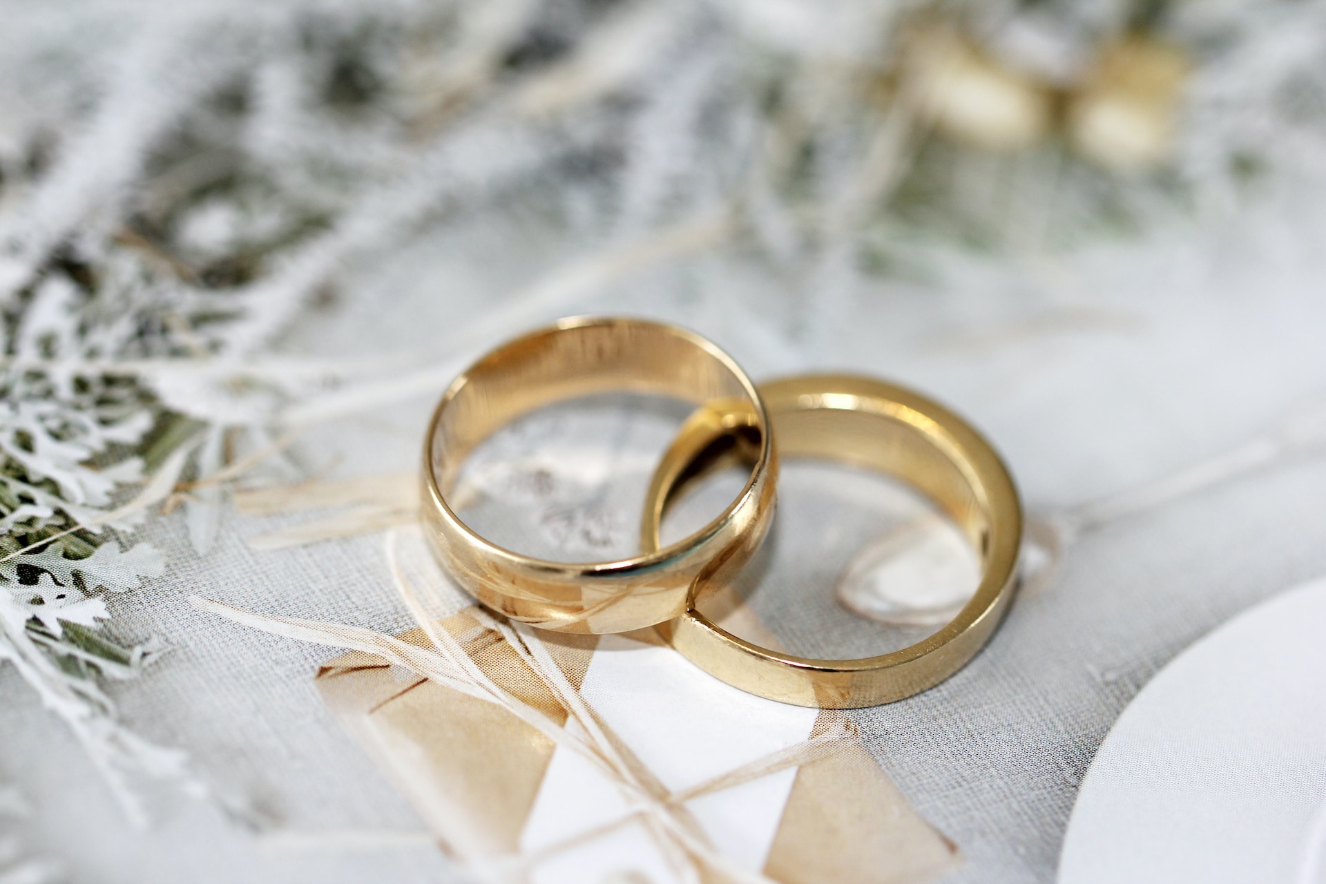 A close-up image of two elegant wedding rings resting together.