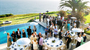 A corporate event in a spacious outdoor setting with attendees mingling and enjoying the fresh air.